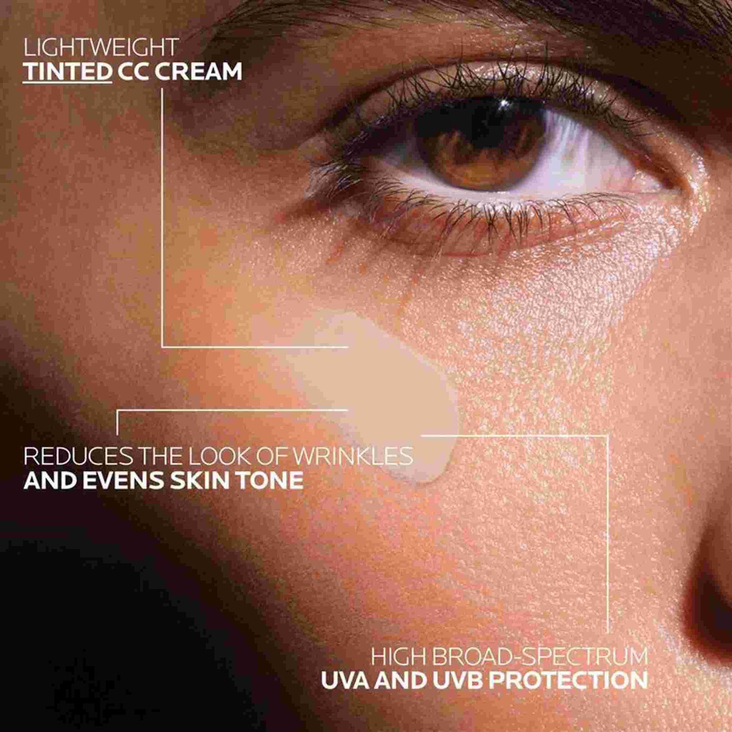 Close-up of a person's eye and cheek with a beige tinted CC cream swatch on the skin and text callouts describing skincare benefits.
